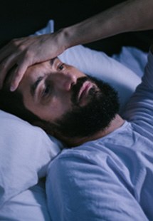 Closeup of man who can't fall asleep in bed