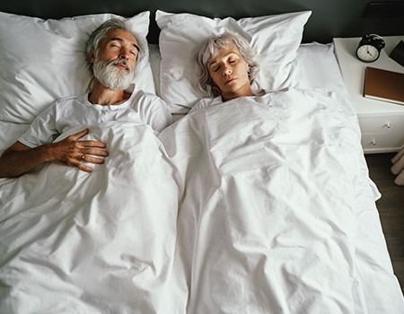 Older couple sleeping peacefully without snoring