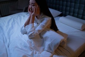 Woman sitting up in bed