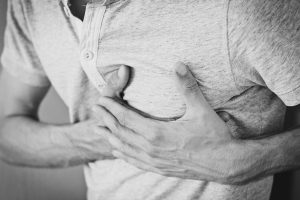 Man holding chest from pain
