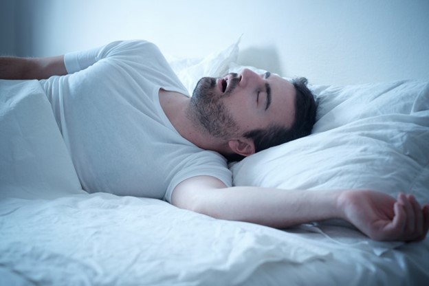 Man snoring because of his sleep apnea.