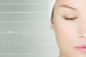 a visual of a woman sleeping and her brain waves